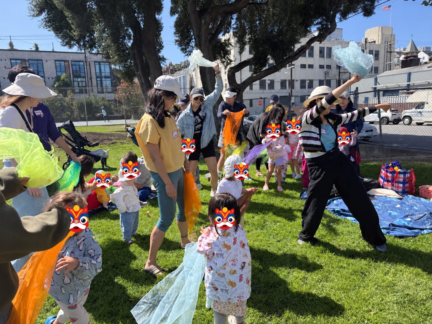 Toddlers and parents waving colorful scarves together